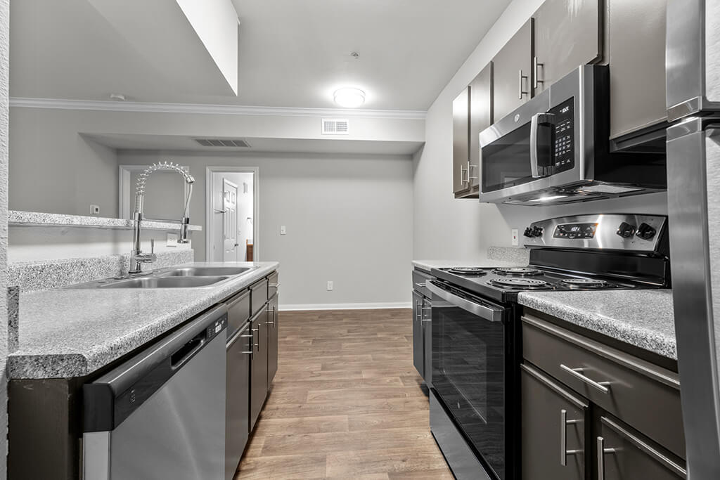 Kitchen with dark cabinets at Mission James Place Apartments in Austin Texas